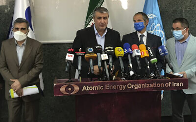 The head of the Atomic Energy Organization of Iran, Mohammad Eslami (center) speaks during a joint press briefing with Director General of International Atomic Energy Agency Rafael Mariano Grossi (second right) in Tehran, Iran, on Sunday, September 12, 2021. (Atomic Energy Organization of Iran via AP)