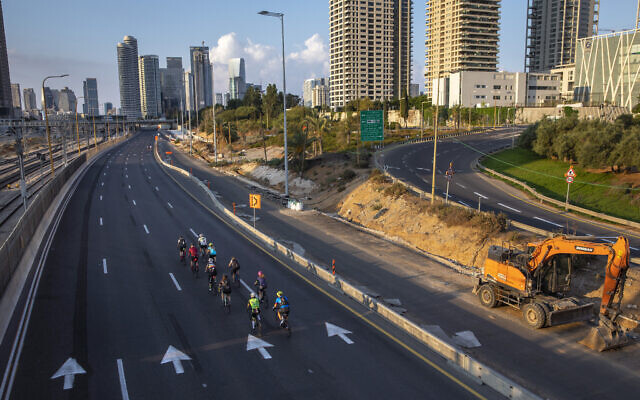 Cyclists ride on a car-free highway, during the Jewish holiday of Yom Kippur in Tel Aviv, Israel, Sept. 16, 2021 (AP Photo/Oded Balilty)