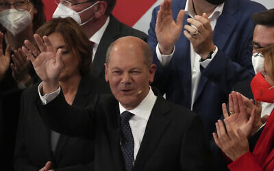 Olaf Scholz, Finance Minister and SPD candidate for Chancellor, waves to his supporters after German parliament election at the Social Democratic Party, SPD, headquarters in Berlin, September 26, 2021. (AP Photo/Michael Sohn)