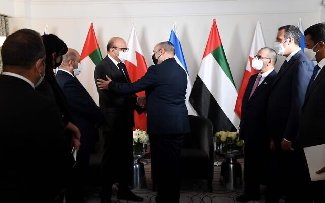Prime Minister Naftali Bennett (C) shakes hands with Bahraini Foreign Minister Abdullatif Al Zayani at his hotel in New York on Sunday evening during a meeting with diplomats from the Gulf (Avi Ohayon/GPO)