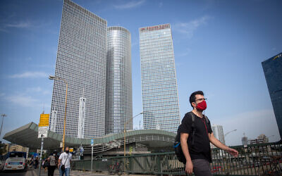 Israelis wear protective face masks near the Azrieli towers in Tel Aviv, on October 25, 2020. (Miriam Alster/Flash90)
