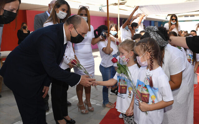 Prime Minister Naftali Bennett and Education Minister Dr. Yifat Shasha-Biton with children at the Eli Cohen Meuhad School in Yeruham, at the start of the new school year, September 1, 2021 (Haim Zach / GPO)