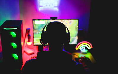 Illustrative: A young man is seen wearing a headset and playing an online video game. (DisobeyArt/iStock by Getty Images)