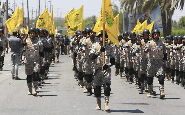Supporters of Iraqi Hezbollah Brigades march in military uniforms during a Quds Day march in Baghdad, Iraq, June 23, 2017. (Hadi Mizban/AP)