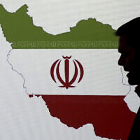 Illustrative: A cybersecurity expert stands in front of a map of Iran as he speaks to journalists about the techniques of Iranian hacking, on September 20, 2017, in Dubai, United Arab Emirates. (AP/Kamran Jebreili)