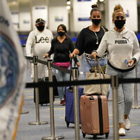 International passengers arrive at Miami international Airport before they are screened by US Customs and Border Protection (CBP) using facial biometrics to automate manual document checks required for admission into the US on November 20, 2020, in Miami, Florida. (AP Photo/ Lynne Sladky)