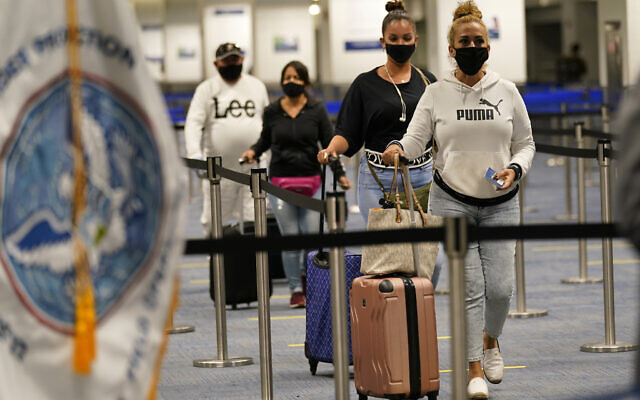 Passengers arrive at Miami International Airport before they are screened by US Customs and Border Protection (CBP) using facial biometrics to automate manual document checks required for admission into the US on November 20, 2020, in Miami, Florida. (AP Photo/ Lynne Sladky)