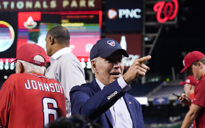 US President Joe Biden points to a fan from the Republican dugout during the Congressional baseball game at Nationals Park Wednesday, Sept. 29, 2021, in Washington. (AP Photo/Alex Brandon)