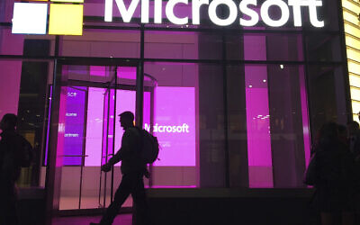 Illustrative: People walk past a Microsoft office in New York, November 10, 2016. (AP Photo/Swayne B. Hall)