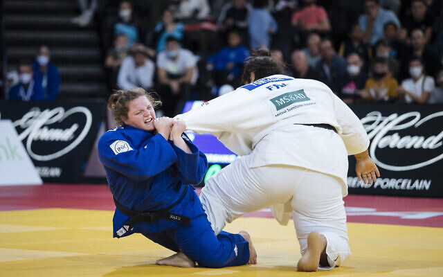 Raz Hershko of Israel, in blue, competes against Lea Fontaine of France during the women's +78kg final match at the Grand Slam Paris 2021 Judo tournament, in Paris, France, Sunday, Oct. 17, 2021. (AP Photo/Lewis Joly)