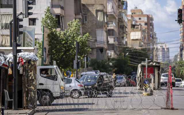 Lebanese army blocks a road by barbed wire that leads to the Ain el-Rumaneh neighborhood after the deadly clashes that erupted a week earlier along a former 1975-90 civil war front-line between Muslim Shiite and Christian areas, in Beirut, Lebanon, on October 19, 2021. (AP Photo/Hassan Ammar)