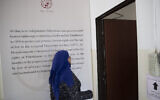 A Palestinian woman walks into the al-Haq human rights group organization's offices in the West Bank city of Ramallah, October 23, 2021. (AP Photo/Majdi Mohammed)