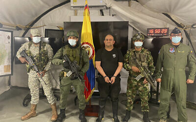 In this photo released by the Colombian presidential press office, one of the country’s most wanted drug traffickers, Dairo Antonio Usuga, alias “Otoniel,” leader of the violent Clan del Golfo cartel, is presented to the media at a military base in Necocli, Colombia, October 23, 2021. (Colombian presidential press office via AP)