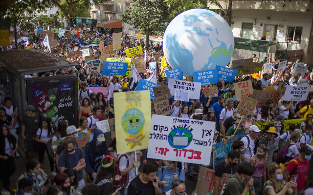 Thousands march through Tel Aviv to call for government action on climate change, on October 29, 2021. (AP Photo/Ariel Schalit)