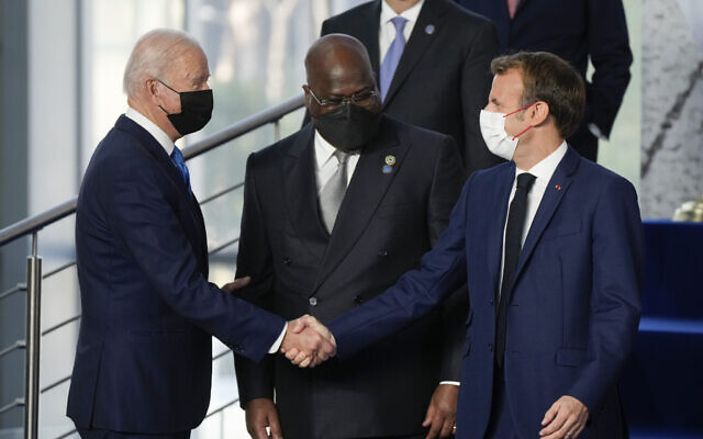 US President Joe Biden greets French President Emmanuel Macron (right), as Democratic Republic of Congo's President and African Union Chair Felix Tshisekedi looks on prior to a group photo of world leaders at the La Nuvola conference center for the G20 summit in Rome, on October 30, 2021. (AP Photo/Gregorio Borgia)