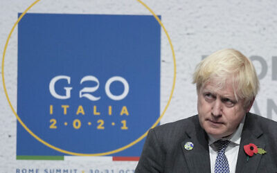 British Prime Minister Boris Johnson listens to a question during a press conference at the La Nuvola conference center for the G20 summit in Rome, October 31, 2021. (AP Photo/Kirsty Wigglesworth)