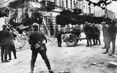 German soldiers try to dislodge snipers in Warsaw during the Nazi invasion of Poland in September 1939 in World War II.  (AP Photo)
