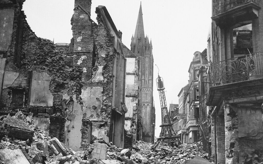 In this photo provided by the US Army Signal Corps, a miniature Eiffel Tower totters amid the wreckage in a street in the French town of Coutances, which was strongly contested by the Germans and Americans, August 3, 1944. The spire of the town's cathedral is in the background. (AP Photo/U.S. Army Signal Corps)