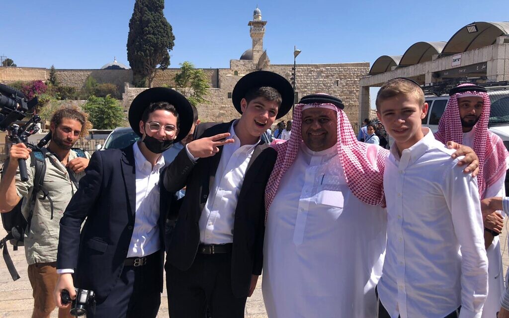 Haredi students pose wih Bahraini education official Mohammed Saleh in the Old City of Jerusalem, October 6, 2021 (Lazar Berman, Times of Israel)