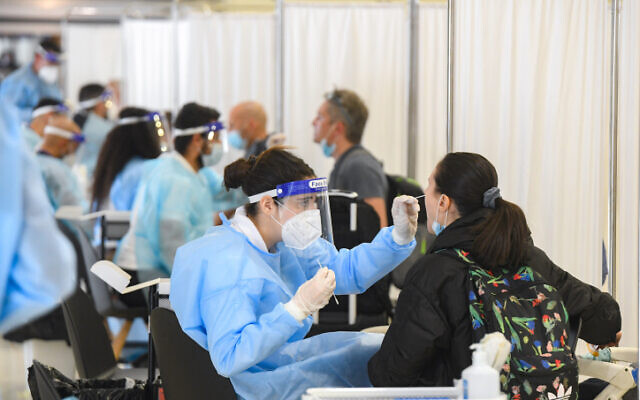 Medical technicians test passengers for COVID-19 at Ben Gurion International Airport, on March 8, 2021. (Flash90)