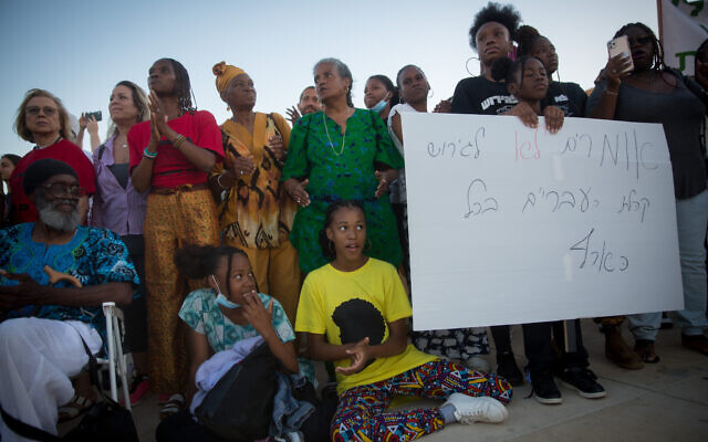 Members of the Black Hebrews community protest against the deportation orders given to some members of the community, at Habima Square in Tel Aviv, June 1, 2021. (Miriam Alster/Flash90)