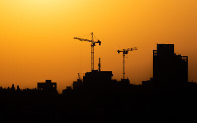 A construction site in Jerusalem against the backdrop of a sunset, September 1, 2021. (Nati Shohat/Flash90)