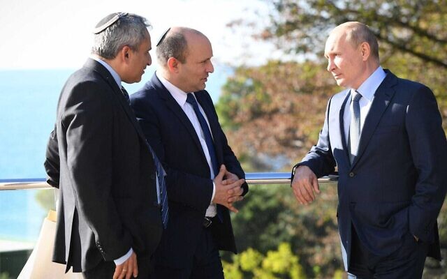 Prime Minister Naftali Bennett (C) speaks with Russian President Vladimir Putin (R) while accompanied by Housing Minister Ze’ev Elkin who acted as a translator at Putin's residence in Sochi, Russia on October 22, 2021. (Kobi Gidon/GPO)