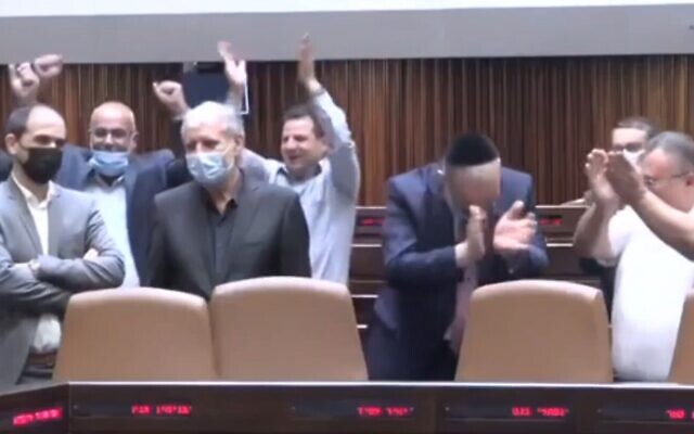 Screen capture from video of opposition lawmaker celebrating the passing of a bill in the Knesset, October 20, 2021. (Channel 12 News)