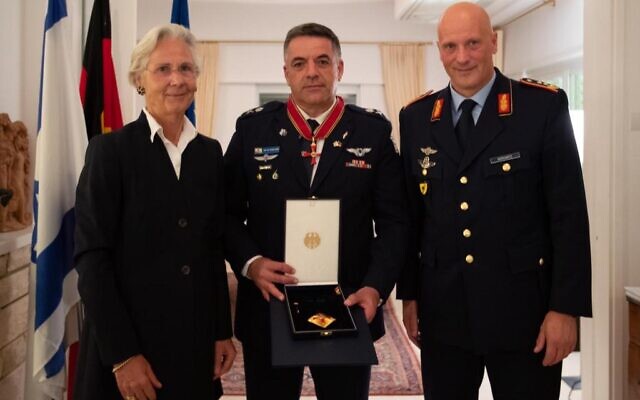 Israeli Air Force chief Amikam Norkin, center, receives the Order of Merit of The Federal Republic of Germany from German Ambassador to Israel, Susanne Wasum-Rainer, and German air force chief Ingo Gerhartz on October 17, 2021. (Israel Defense Forces)