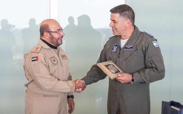 Emirati air force chief Ibrahim Nasser Muhammed al-Alawi, left, shakes hands with Israeli Air Force chief Amikam Norkin after he lands in Israel to observe to observe the IAF's Blue Flag exercise on October 25, 2021. (Israel Defense Forces)