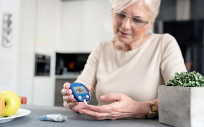 A diabetic woman checking blood sugar level at home. (iStock via Getty Images)