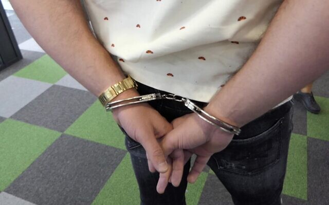 An employee of the Bulgarian call center Dortome BG is handcuffed on October 6, 2021, during a Europol-coordinated raid (Source: Bulgarian Interior Ministry)