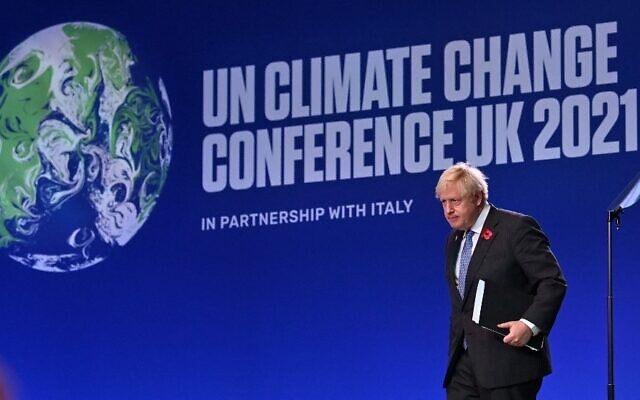 Britain's Prime Minister Boris Johnson leaves the stage after speaking during the opening ceremony of the COP26 UN Climate Change Conference in Glasgow, Scotland on November 1, 2021. (Photo by Paul ELLIS / AFP)