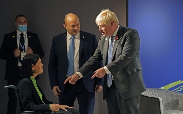 Britain's Prime Minister Boris Johnson (R) is introduced to Israel's Energy Minister Karine Elharrar (L) as he meets with Israel's Prime Minister Naftali Bennett (C) on the sidelines of the COP26 Climate Conference at the Scottish Event Campus in Glasgow, Scotland on November 2, 2021. (Alberto Pezzali / POOL / AFP)