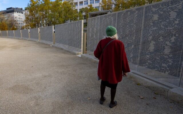 A woman is seen at Shoah Name Wall Memorial in Vienna on the occasion of its inauguration on November 9, 2021. (GEORG HOCHMUTH / APA / AFP)