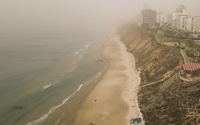 This aerial view shows dust blanketing Netanya on November 13, 2021 (JACK GUEZ / AFP)