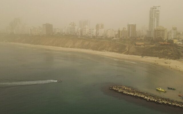 This aerial view shows dust and haze blanketing Netanya on November 13, 2021 (JACK GUEZ / AFP)