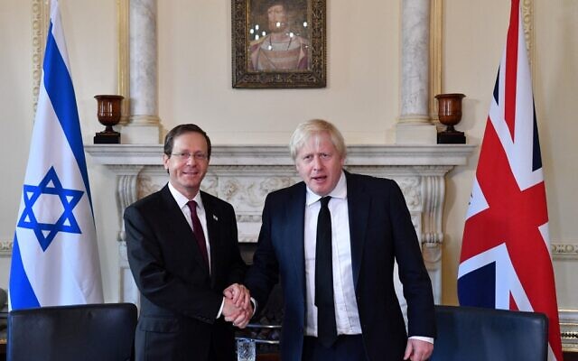 Britain's Prime Minister Boris Johnson (R) shakes hands with Israeli President Isaac Herzog ahead of talks inside Number 10 Downing Street in central London on November 23, 2021 during the Israeli president's three-day visit. (JUSTIN TALLIS / POOL / AFP)