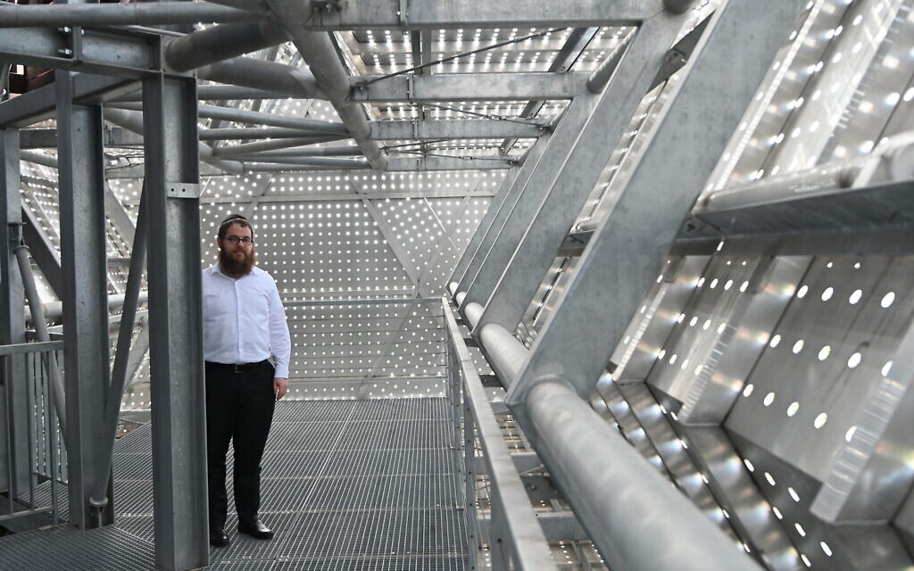 Rabbi Slomo Koves stands inside the Star of David-shaped elevated corridor at the House of Fates Holocaust museum, housed in a former railway station that deported Jews to concentration camps, seen in Budapest, Hungary, on August 27, 2021. (Cnaan Liphshiz/JTA)