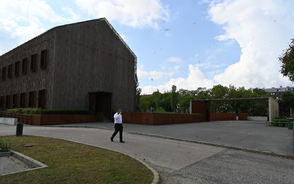 Rabbi Slomo Koves walks across the parking area of the House of Fates Holocaust museum in Budapest, Hungary on August 27, 2021. (Cnaan Liphshiz)