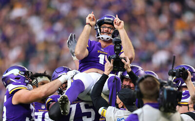 Greg Joseph celebrates with his Minnesota Vikings teammates after kicking a game-winning field goal against the Green Bay Packers at US Bank Stadium in Minneapolis, November 21, 2021. (Adam Bettcher/Getty Images/ via JTA)