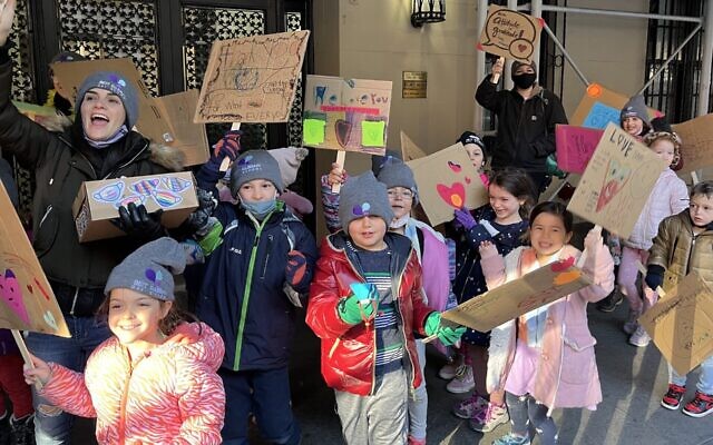 Students and parents from Beit Rabban Day School in Manhattan march to express their gratitude to neighborhood workers on the Upper West Side on the eve of Thanksgiving, on November 24, 2021. (Laura Kaler via JTA)