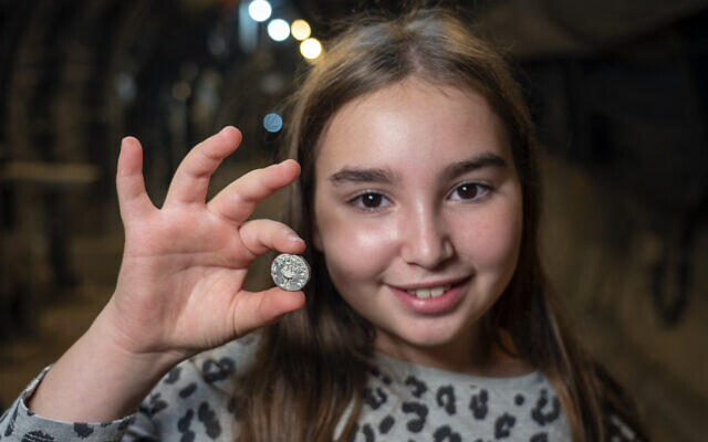 Liel Krutokop, with the rare silver coin she found (Yaniv Berman/City of David and the Israel Antiquities Authority)