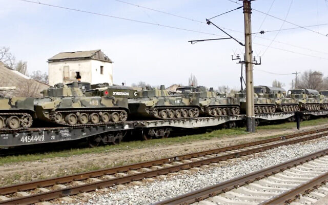 File: This handout photo taken from a video released on Friday, April 23, 2021, by Russian Defense Ministry Press Service shows, Russian military vehicles stand on railway platforms to be carried back to their base after drills in Crimea (Russian Defense Ministry Press Service via AP)