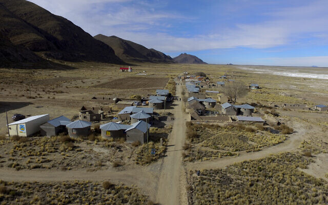 Residents walk along a dirt road in the Urus del Lago Poopo indigenous community, which sits along the salt-crusted former shoreline of Lake Poopo, in Punaca, Bolivia, Monday, May 24, 2021. Bolivia’s second-largest lake dried up about five years ago, victim of shrinking glaciers, water diversions for farming and contamination. (AP Photo/Juan Karita)