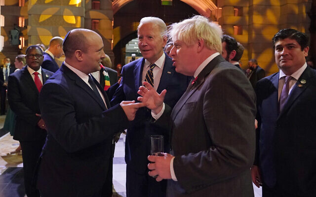 Prime Minister Naftali Bennett, US President Joe Biden and British Prime Minister Boris Johnson chat as they attend an evening reception to mark the opening day of the COP26 UN Climate Summit, in Glasgow, Scotland,  on Monday, November 1, 2021. (AP Photo/Alberto Pezzali, Pool)