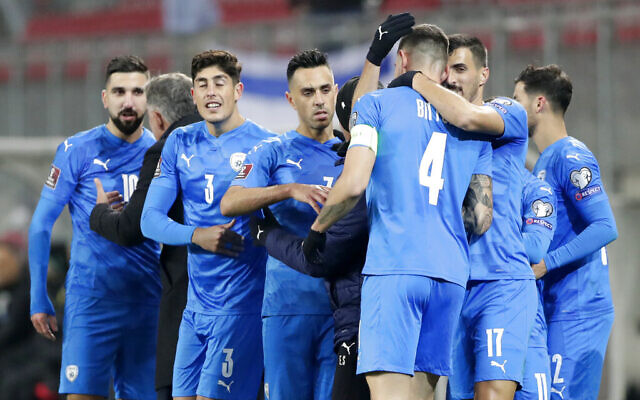 Israel's national soccer team celebrates the opening goal during the World Cup 2022 group F qualifying soccer match between Austria and Israel in Klagenfurt, Austria, November 12, 2021. (Lisa Leutner/AP)