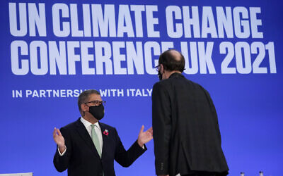 Alok Sharma, left, President of the COP26 summit, attends a plenary session at the UN Climate Summit, in Glasgow, Scotland, Saturday, Nov. 13, 2021. (AP/Alberto Pezzali)