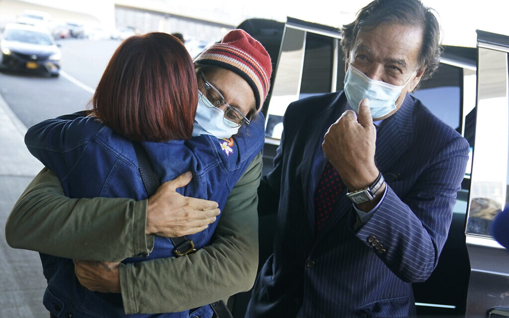 Danny Fenster, center, hugs his mother Rose Fenster as former U.S. diplomat Bill Richardson, right, looks on at John F. Kennedy Airport in New York, Tuesday, Nov. 16, 2021.  (AP Photo/Seth Wenig)