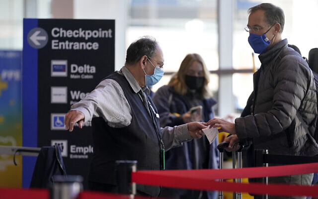 Travelers enter a security checkpoint at Logan International Airport, in Boston, November 24, 2021. (AP Photo/Steven Senne)